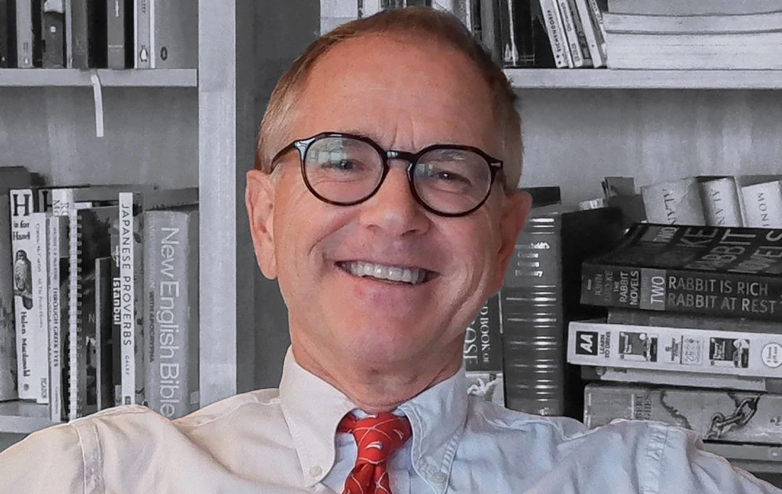 Guy Nobes, your university admissions adviser, smiling in his study